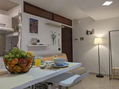 a kitchen with a table with a bowl of fruit on it at Iverlid Ballarò in Palermo