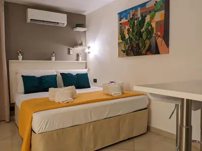 a bedroom with a bed with towels on it at Iverlid Ballarò in Palermo