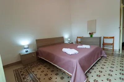 a bedroom with a bed with two towels on it at Holiday House Marconi in Castellammare del Golfo