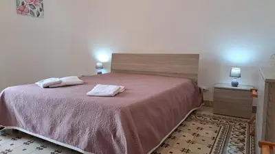 a bedroom with a bed with two towels on it at Holiday House Marconi in Castellammare del Golfo
