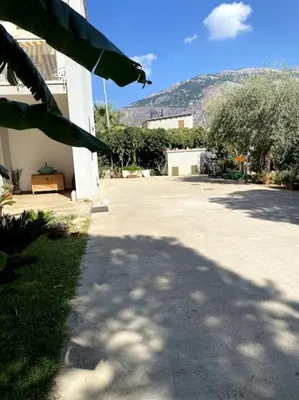 a shadow of a building on a driveway at Casa Woow in Carini