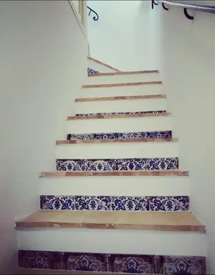 a stairway with blue and white tiles on it at Casa del Pescatore Terrasini in Terrasini