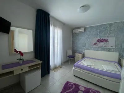 a bedroom with a bed and a sink and a mirror at B&B Le Onde Del Mare in San Vito lo Capo