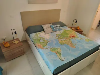 a bed with a map of the world on it at Peri Peri House - Palermo Centro in Palermo