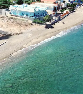 an aerial view of a beach with houses and the ocean at Blue Life, sea-luxury rooms on the beach between Palermo and Cefalu' in Casteldaccia