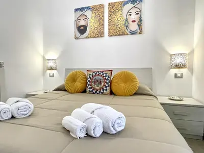 a small room with a desk and a blue couch at I MORI - Holiday Rooms in Lascari