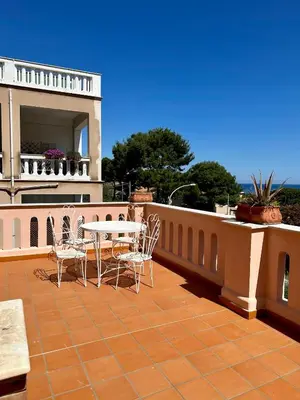 a patio with a table and chairs on a balcony at Casa Stella Splendida Villa sul Mare in Palermo