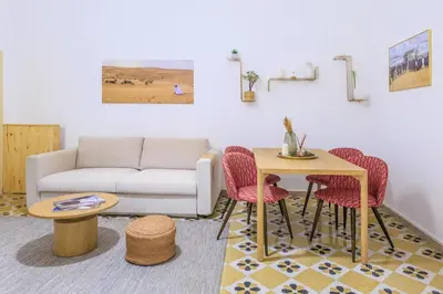a living room with a couch and a table and chairs at Vintage Rooms in Palermo