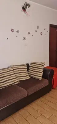 a couch in a living room with paws on the wall at La casa di Minù in Palermo