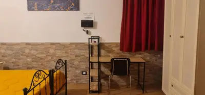 a dining room with a table and a red curtain at La casa di Minù in Palermo