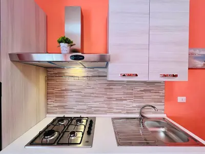 a kitchen with a stove and a sink at Domus Aurea in Isola delle Femmine