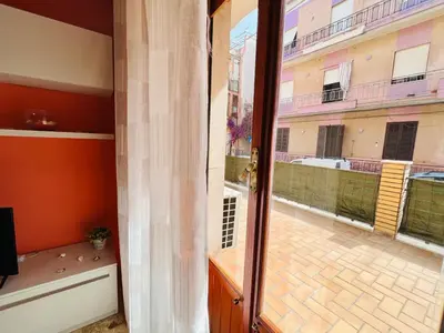 a door to a balcony with a view of a courtyard at Domus Aurea in Isola delle Femmine