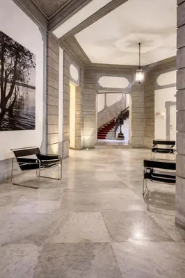 a lobby with chairs and a painting on the wall at Palazzo Moncada appartamento 2 in Palermo