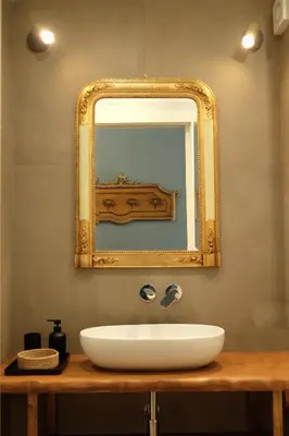 a bathroom with a white sink and a mirror at Sette Fate Suites & Spa in Palermo