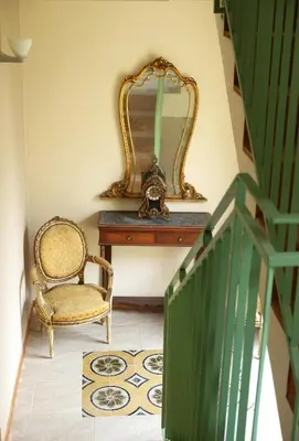 a mirror sitting on a table next to a chair at Sette Fate Suites & Spa in Palermo