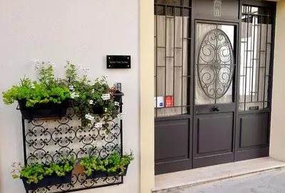 a door of a building with flowers and plants at Sette Fate Suites & Spa in Palermo