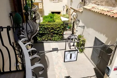 an alley with a clock on the side of a building at Sette Fate Suites & Spa in Palermo