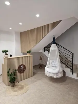 a room with a staircase with a chair and a table at The waves in Terrasini