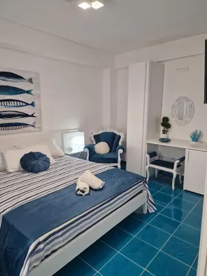 a bedroom with a bed with a dog laying on the floor at The waves in Terrasini