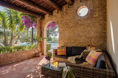 a patio with a couch and a table at Cleo - Villa Siciliana in Partinico