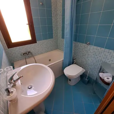 a bathroom with a sink and a toilet and a tub at PTA Appartavilla in Campofelice di Roccella