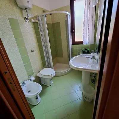 a bathroom with a sink and a toilet and a shower at PTA Appartavilla in Campofelice di Roccella