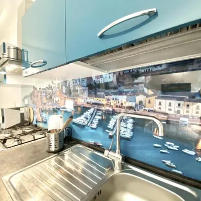 a kitchen sink with a view of a harbor at Appartamento Alexa in Castellammare del Golfo
