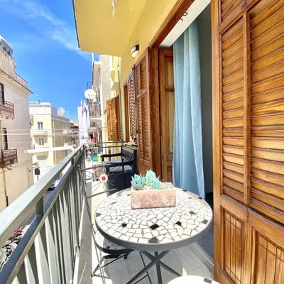 a table on the balcony of a building at Appartamento Alexa in Castellammare del Golfo