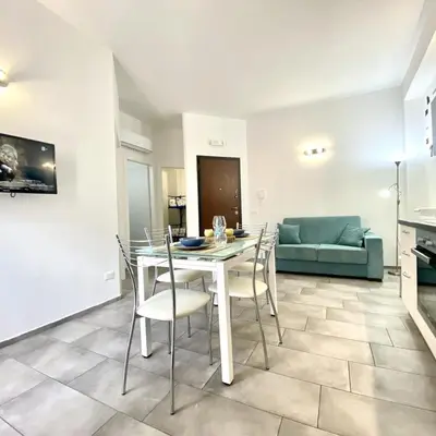 a living room with a table and chairs and a couch at Appartamento Alexa in Castellammare del Golfo