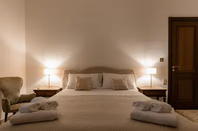 a bedroom with a bed with towels on it at Gardenia Home in Palermo