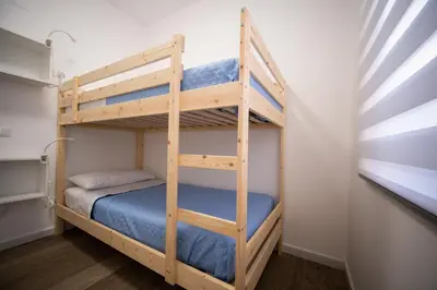 a bunk bed room with two bunk beds in a room at Matilde’s Holiday House in Terrasini