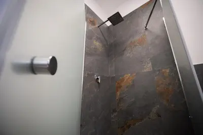 a shower stall with a door with a metal at Matilde’s Holiday House in Terrasini