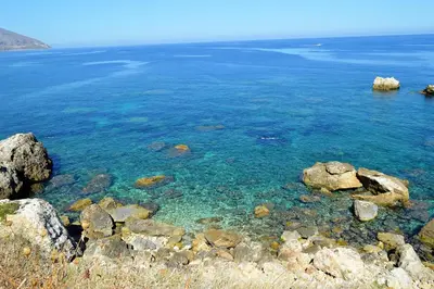 a large body of water with rocks in the water at Casa Diomeda in Scopello