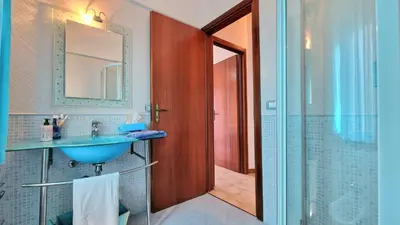 a bathroom with a blue sink and a shower at Casa Richilde in Scopello