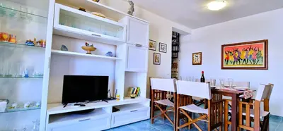 a dining room with a table and a television at Casa Richilde in Scopello