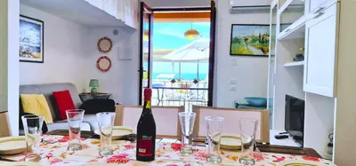a bottle of wine sitting on a table with glasses at Casa Richilde in Scopello