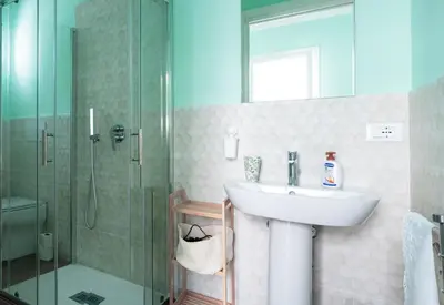 a bathroom with a sink and a shower at 3B Mondello Apartments in Palermo