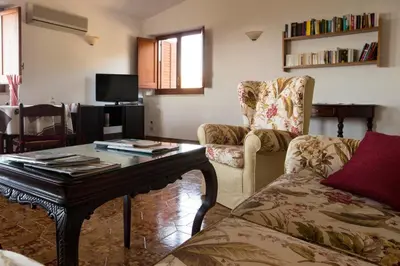 a living room with a couch and a coffee table at Villa Duca Country House in Castellammare del Golfo