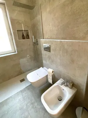 a bathroom with a sink and a toilet and a shower at Il Poggio Retreat - Cefalù in Cefalù