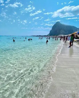 a group of people in the water at the beach at Il Giardino del Sol in San Vito lo Capo