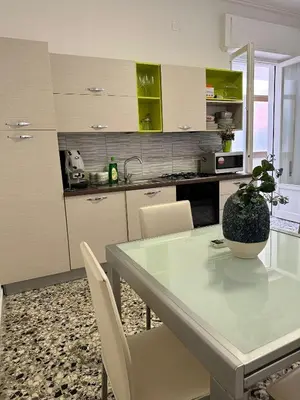 a kitchen with a table with a potted plant on it at STABILE APARTMENT in Palermo