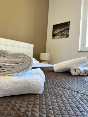 a room with a bed with towels on the floor at STABILE APARTMENT in Palermo