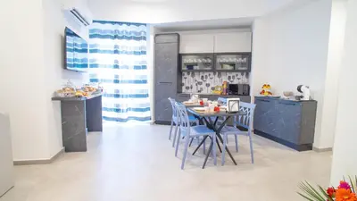 a kitchen with a table and chairs in a room at Palermo Historia in Palermo