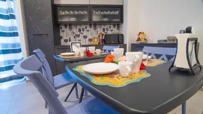 a dining room table with chairs and a table with plates at Palermo Historia in Palermo
