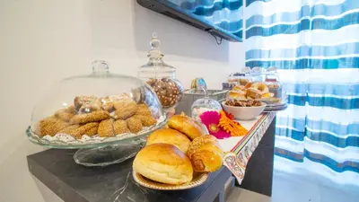a buffet with bread and pastries on a table at Palermo Historia in Palermo