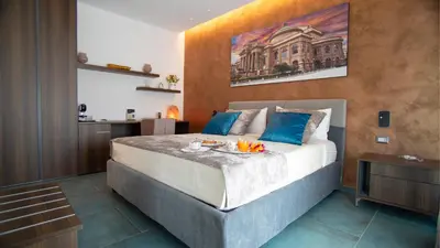 a bedroom with a large bed with blue pillows at Palermo Historia in Palermo