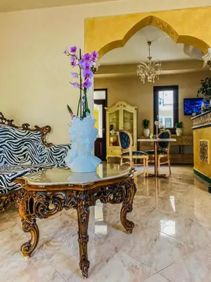 a vase with flowers on a table in a room at Araba Fenice Hotel in San Vito lo Capo