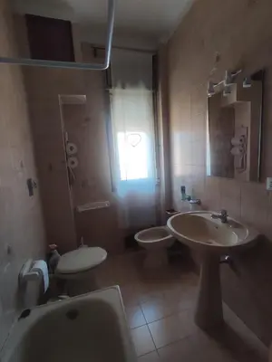 a bathroom with a sink and a toilet and a shower at La casetta di Alice in Palermo