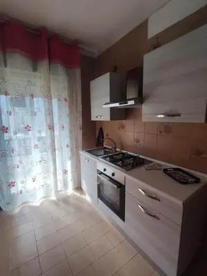 a kitchen with a sink and a stove top oven at La casetta di Alice in Palermo