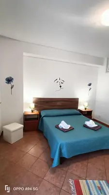 a bedroom with a blue bed with two towels on it at casa vacanze Vita 2 in Balestrate